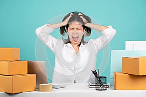 Young woman troubled stressed wear casual shirt sit work at white office desk with pc laptop and cardboard box hold sctratch head