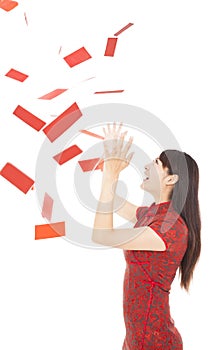 Young woman trying to catch red envelope