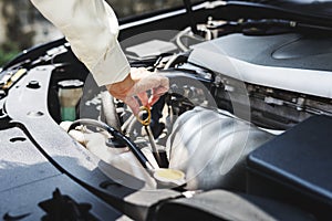 Young woman trying to fix the car