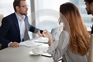 Young woman trying to relax at difficult negotiations.