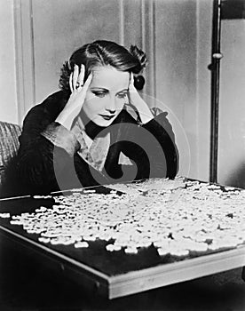 Young woman trying to solve a puzzle