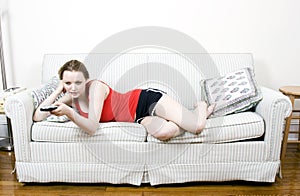 Young woman with TV remote