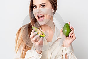 Young woman with two avocado