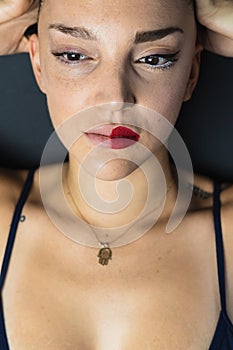 Young woman with two different lipsticks