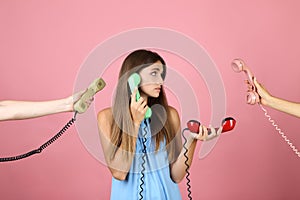 Young woman and two hands with handsets