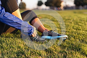 Young woman tying shoelace of sneakers to make outwork training running. Fitness and healthy lifestyle