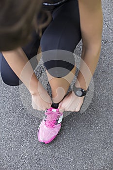 Young woman tying shoelaces