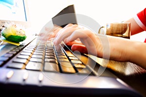 Young woman typing fast on a keyboard