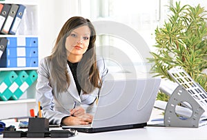 young woman typing on laptop computer