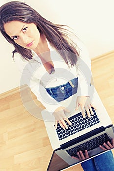 Young woman typing on laptop computer