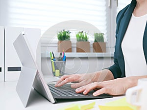 Young woman typing on the laptop keyboard. Home office, online business marketing or learning concept. Online shopping, booking