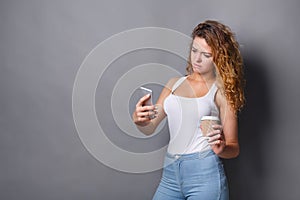 Young woman typing message on smartphone