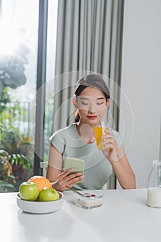 Young woman typing a text message on mobile phone