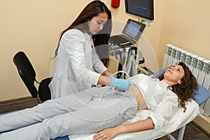 Young woman on the ultrasound, health check with the doctor