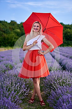 Young woman with umbrella in lavender field