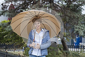 Young woman with umbrella on a walk in the park