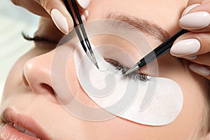 Young woman undergoing eyelash extension procedure