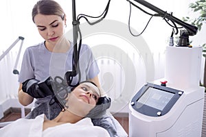 young woman undergoing laser resurfacing and peeling procedure photo