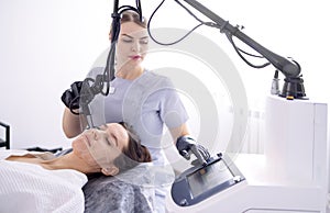 young woman undergoing laser resurfacing and peeling procedure photo