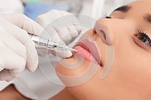 Young woman undergoing procedure of permanent lip