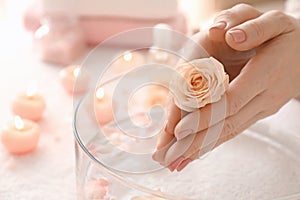 Young woman undergoing spa manicure treatment in beauty salon, closeup