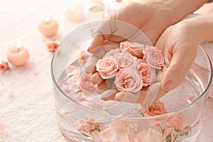 Young woman undergoing spa manicure treatment in beauty salon, closeup