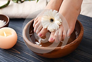 Young woman undergoing spa pedicure treatment in beauty salon, closeup