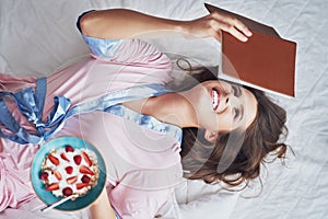 Young woman in underwear eating cereals