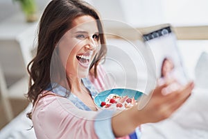 Young woman in underwear eating cereals
