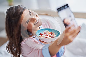 Young woman in underwear eating cereals