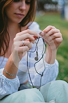 Young woman untangling earphones wire