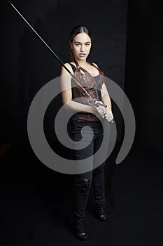 Young woman in urban fantasy poses on a black background