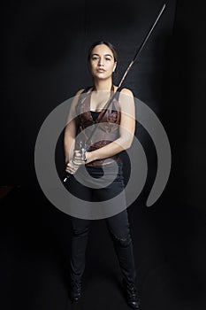 Young woman in urban fantasy poses on a black background