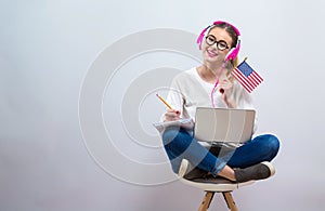 Young woman with USA flag using a laptop computer
