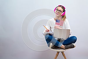 Young woman with USA flag using a laptop computer