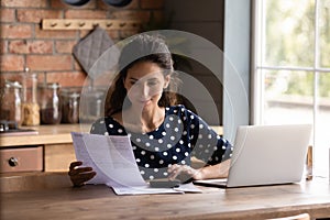 Young woman use computer paying bills online