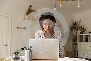 Young woman use laptop gadget at home office