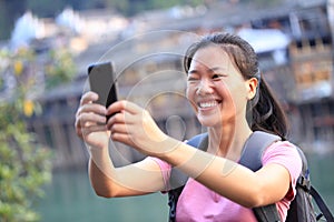 Young woman use smart phone at fenghuang ancient t