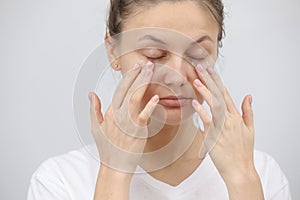 Young woman uses eye cream. Girl care of healthy clean skin use spa treatment lotion. Closeup portrait