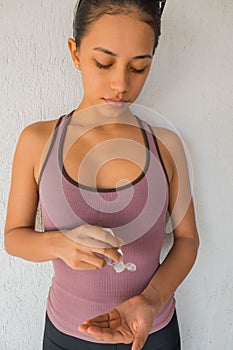 Young woman uses her hand to press hand sanitizer bottle to clean her hand. Hand sanitizer alcohol gel rub clean hands hygiene