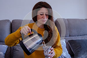Young woman uses hot water to drink yerba mate