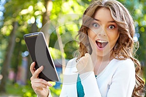 Young woman uses tablet pc.