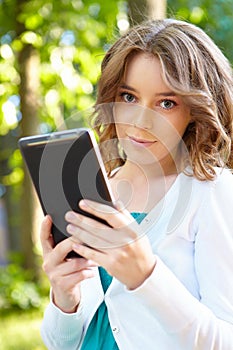 Young woman uses tablet pc.
