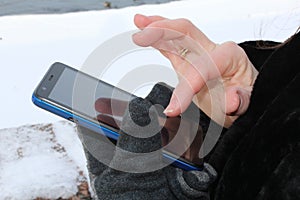 Young woman using apps on a mobile touchscreen smartphone.