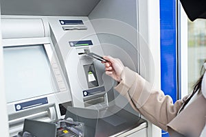 Young woman using ATM photo