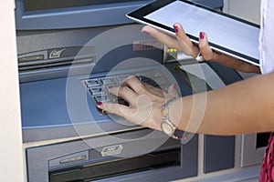 Young woman using ATM