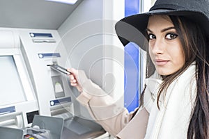 Young woman using the ATM photo