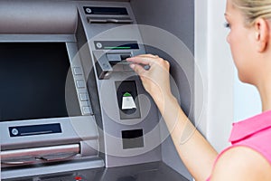 Young woman using a ATM