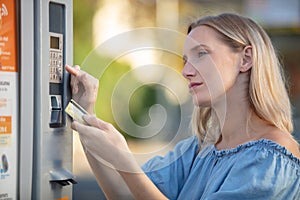 young woman using atm