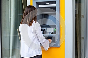 Young Woman Using Automatic Teller Machine